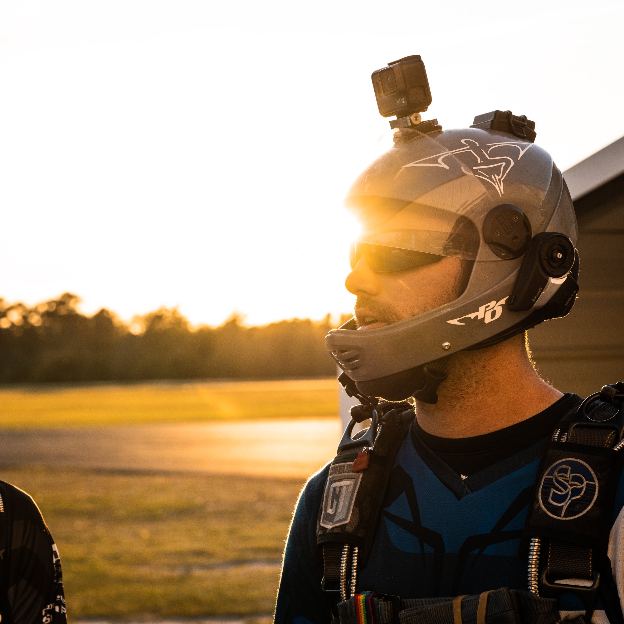 Man wearing a grey cookie skydiving helmet with a GoPro on top